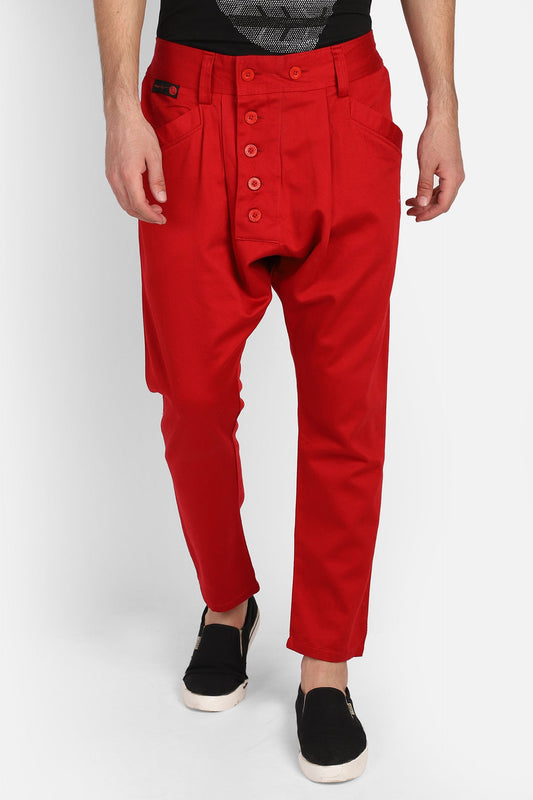 Stylish model wearing trendy red harem pants with button details and a relaxed fit