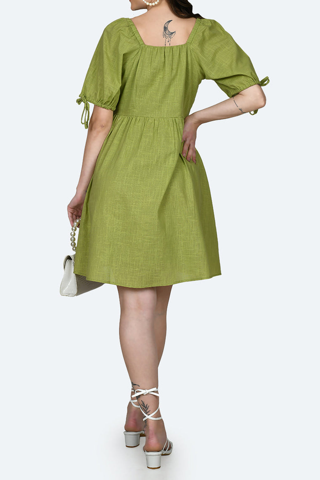 Back view of a stylish green short dress with puff sleeves by Dirty Labels for casual outings