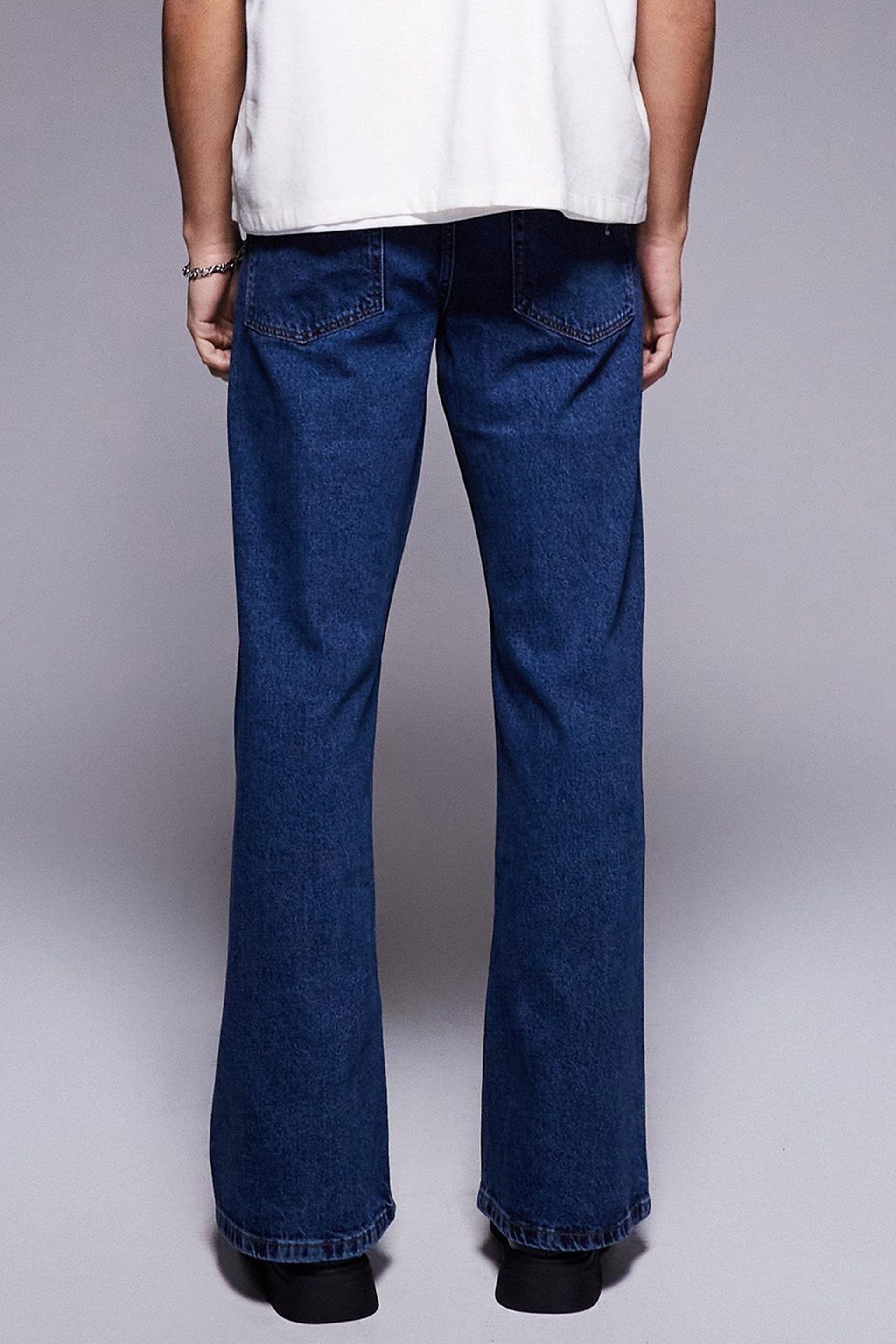 Back view of vintage flared jeans for women featuring a classic blue denim design