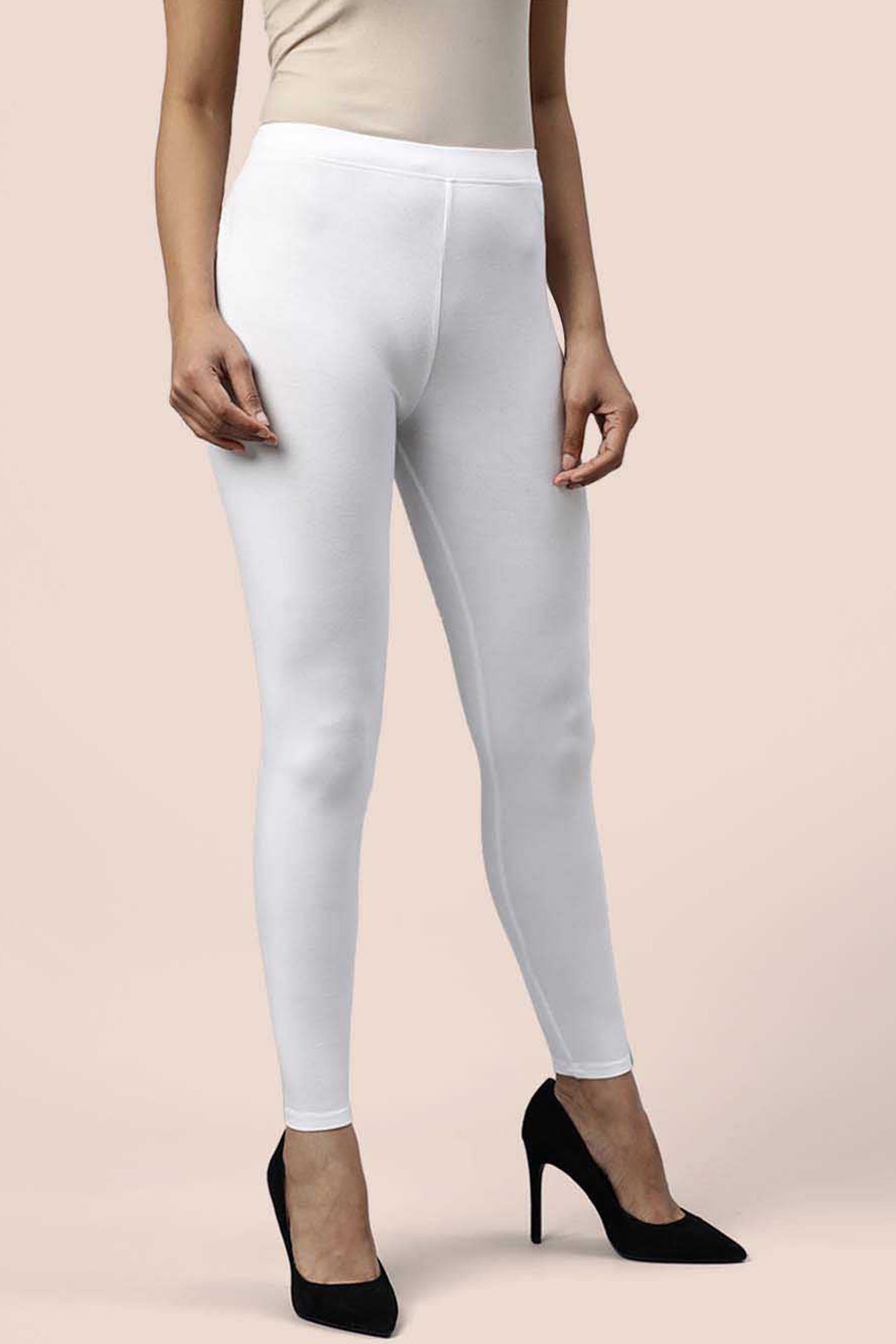 Model wearing white cotton ankle leggings paired with stylish black heels for a chic look