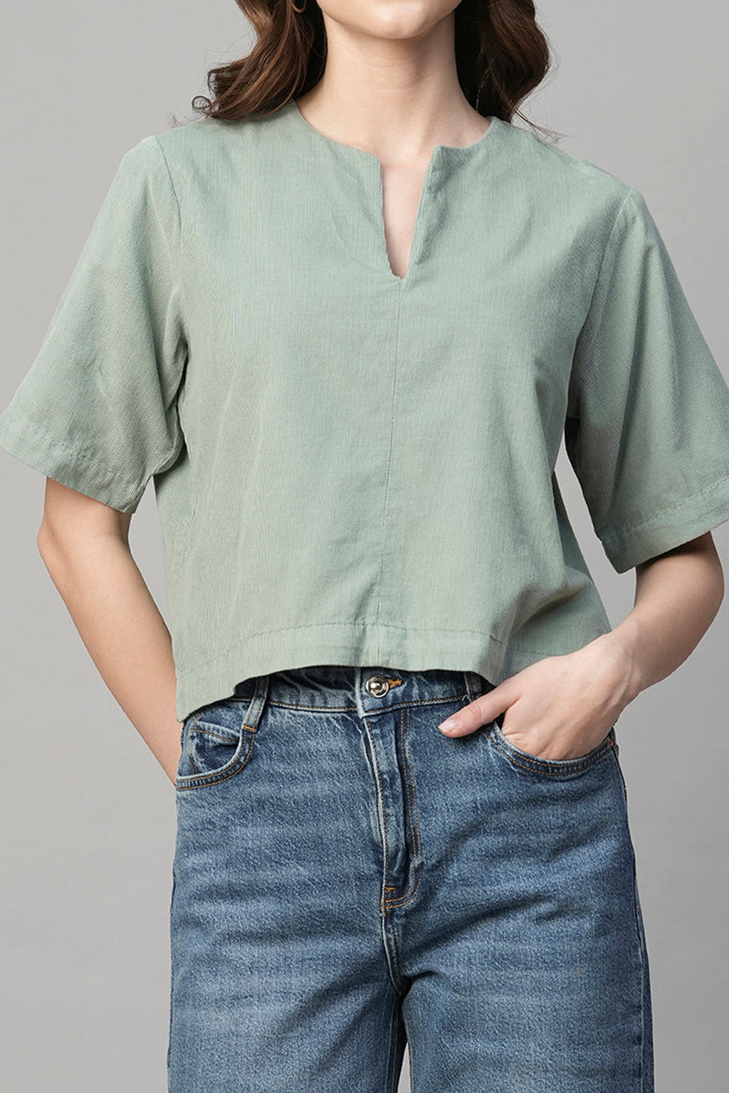 Light green women's corduroy blouse with a relaxed fit and short sleeves