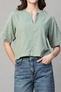 Light green women's corduroy blouse with a relaxed fit and short sleeves