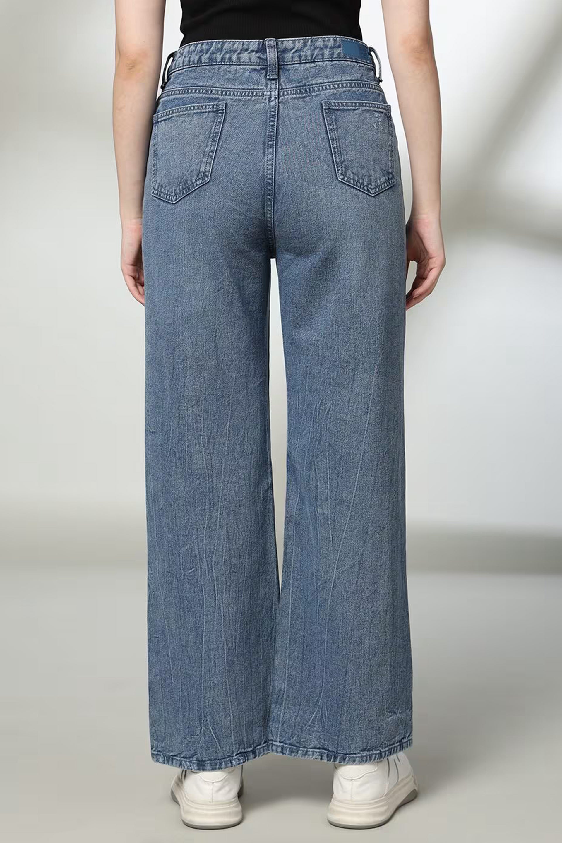 Back view of women's distressed wide-leg jeans from Dirtylabels featuring a relaxed fit and large pockets