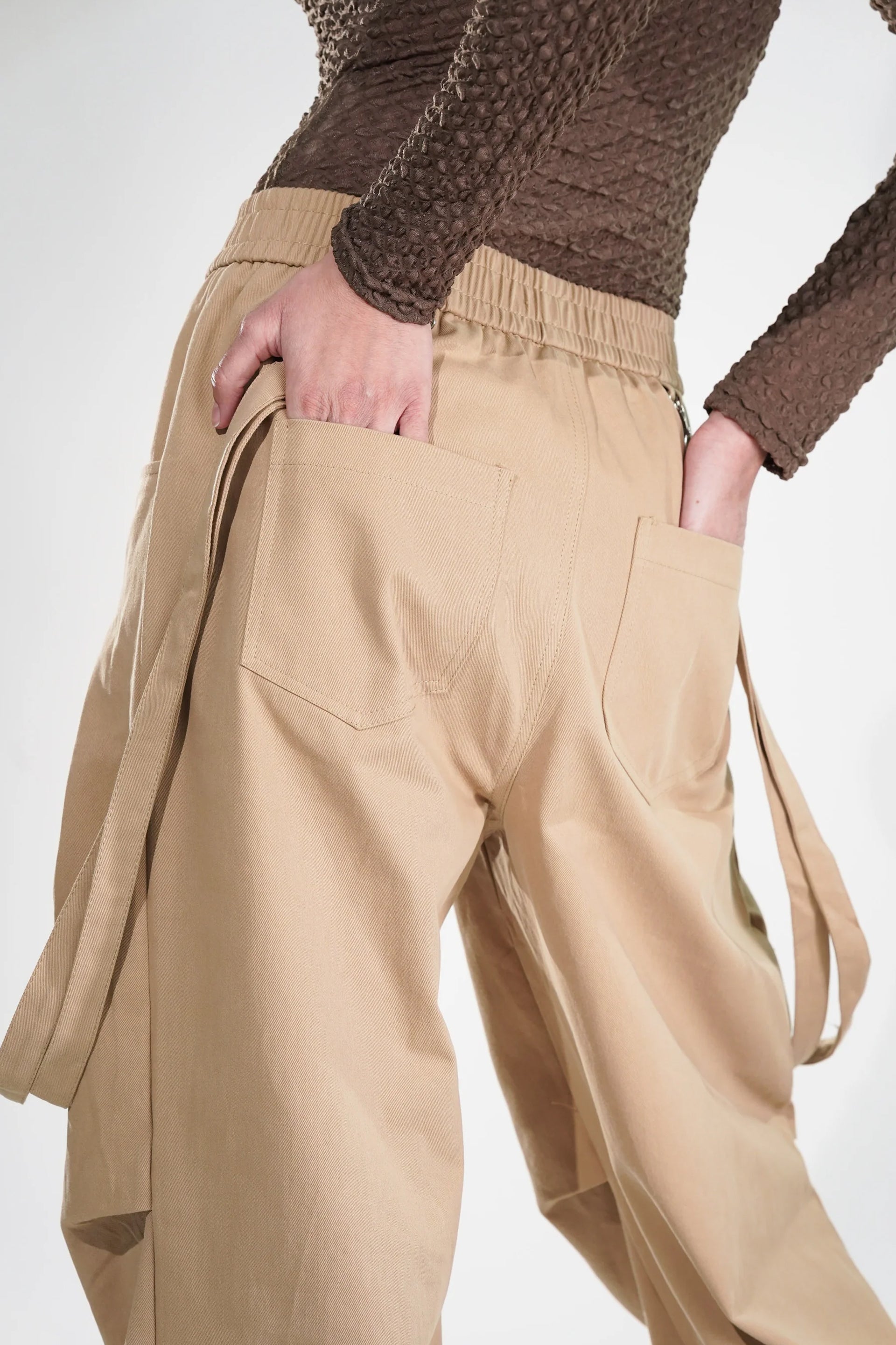 Tan women's fashion cargo pants with spacious pockets and a relaxed fit