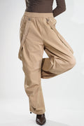 Tan women's fashion cargo pants with a relaxed fit and stylish zipper details