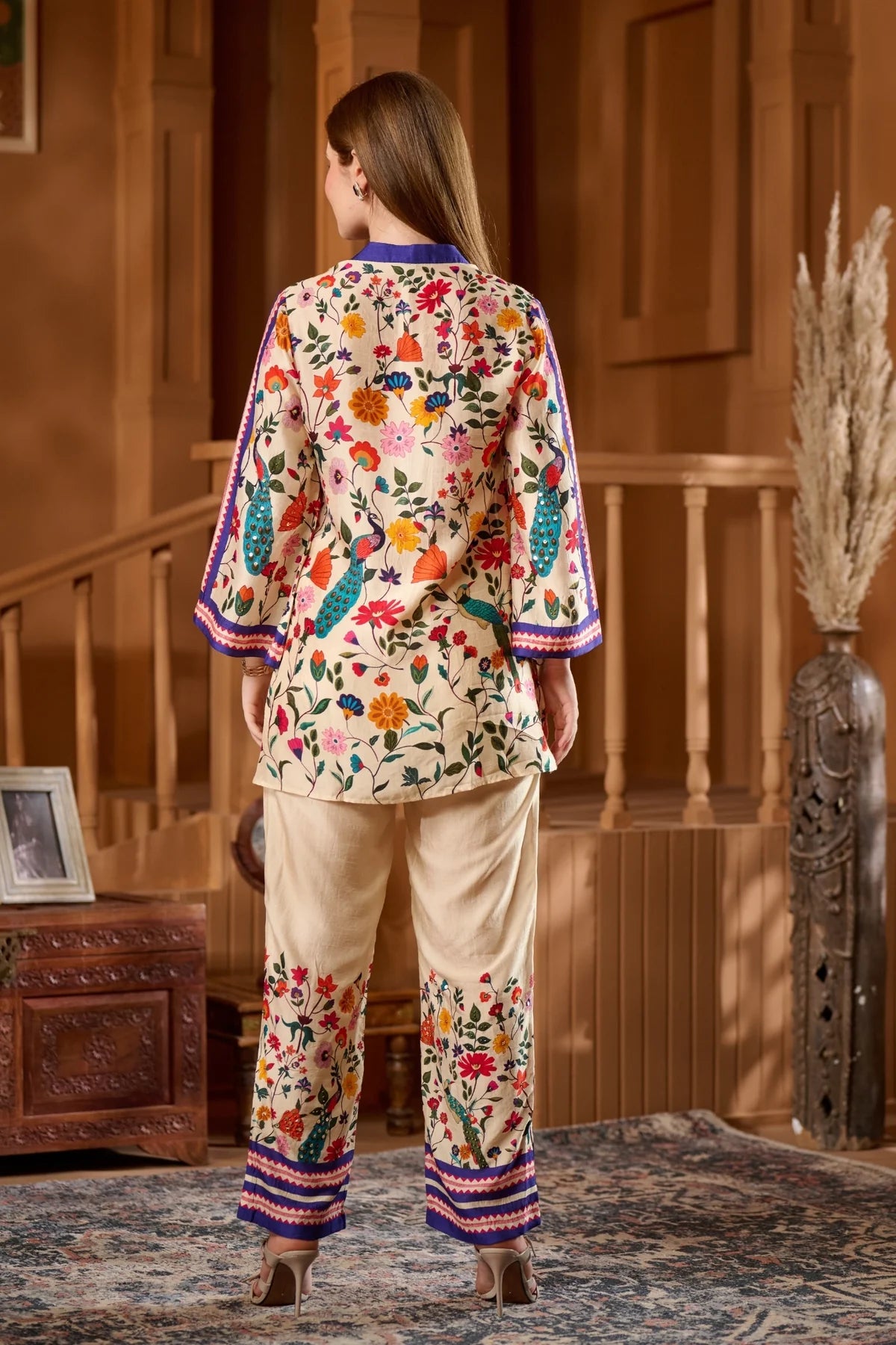 Elegant women's raw silk ethnic wear online featuring colorful floral embroidery and traditional design